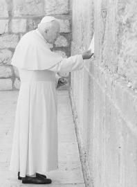 Pope John Paul II places a signed note into a crack in the Western Wall in Israel. (AP/WIDE WORLD PHOTOS)
