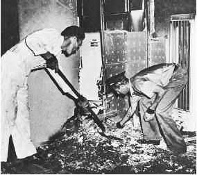 Men sifting through the aftermath of an alleged spontaneous combustion incident. (FORTEAN PICTURE LIBRARY)